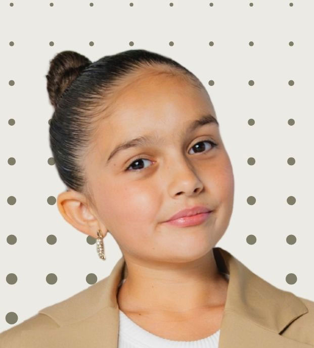 Taylen Biggs profile in a tan blazer and hair tied back.