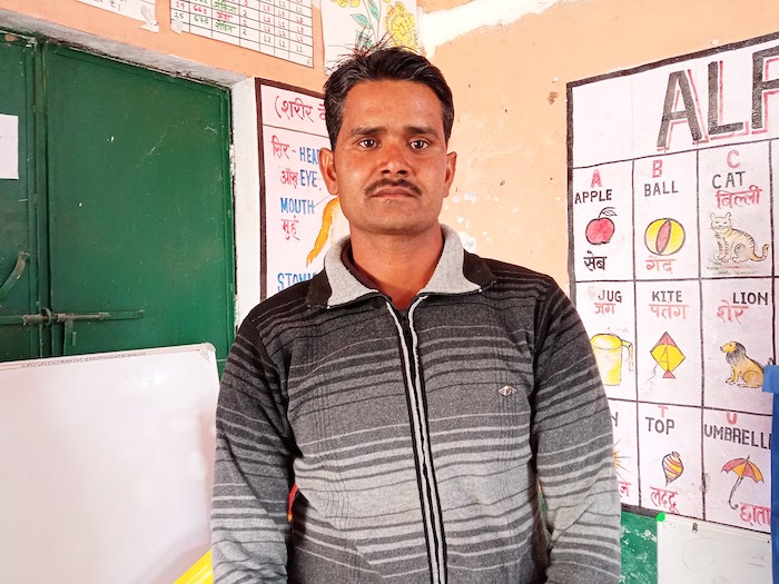 Dinesh, 35, listens with his wife to the 'Friendly' messages delivered by mobile phone about how to support their 3-year-old daughter's early development.