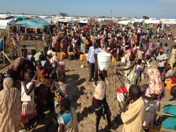 Families gather at a UNICEF water collection point in Bentiu, South Sudan.