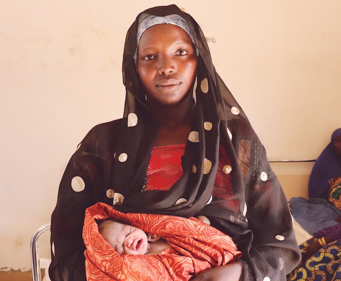 Fanna, 15, holds the newest member of her family: her 13-year-old sister Huawa's baby boy, born a few hours before in Banki, Borno state, Nigeria.