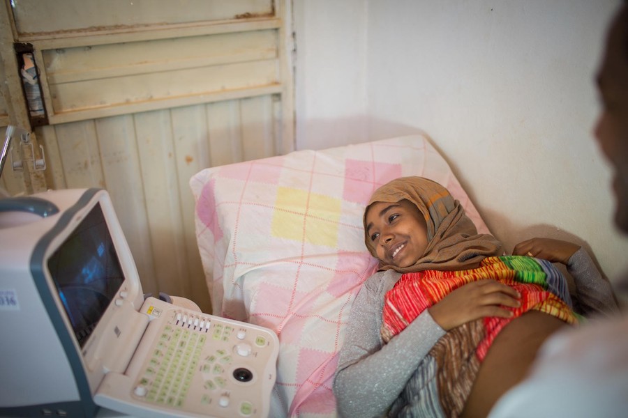 Jamila Seid smiles as she looks at the ultrasound scan of her healthy fetus at a UNICEF-supported health center in Homosha, Ethiopia.