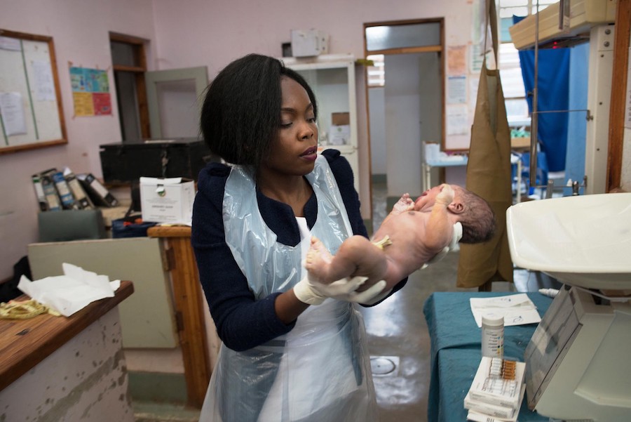 Midwife Dorothy Laina Palani washes, checks and weighs a newborn at Zomba Central Hospital in Zomba, Malawi.
