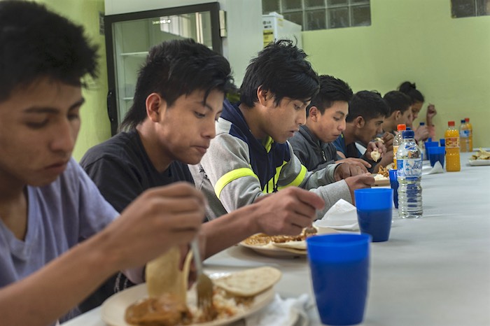 Eight migrant teens eat lunch in a Guatemalan shelter after deportation. They were detained in Mexico on July 4, 2016 while attempting to travel to the U.S.