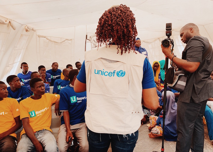 A UNICEF C4D (Communication for Development) officer speaks with U-Report members in Bono camp, Maiduguri, North-East Nigeria.