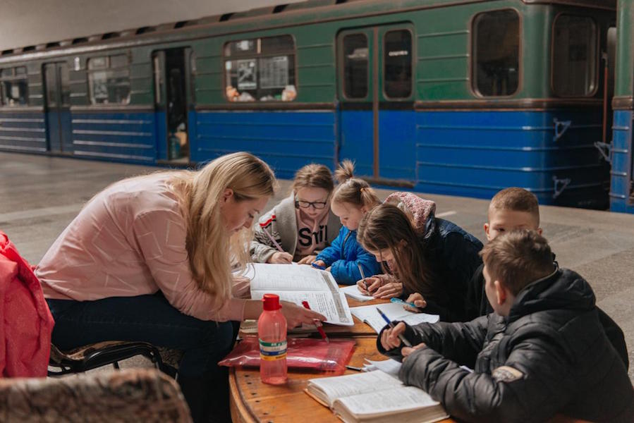 Children use notebooks and other supplies provided by UNICEF to study at a shelter in the Kharkiv metro.