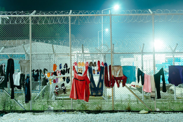 Refugees in limbo in Greece drying their clothes on a fence.