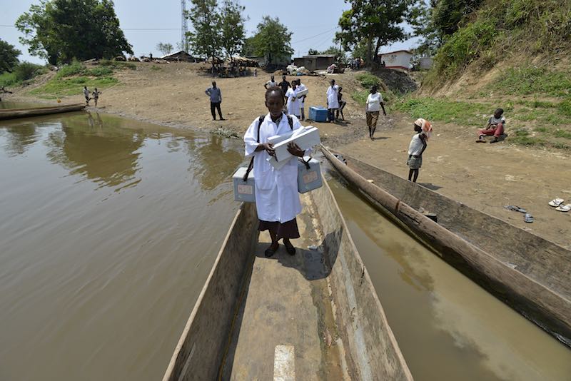 Health workers in the Central African Republic -- CAR -- loading a canoe to bring vaccines to children.