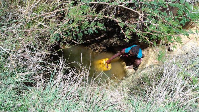 A girl fetches water from an unsafe source in Southern Madagascar.