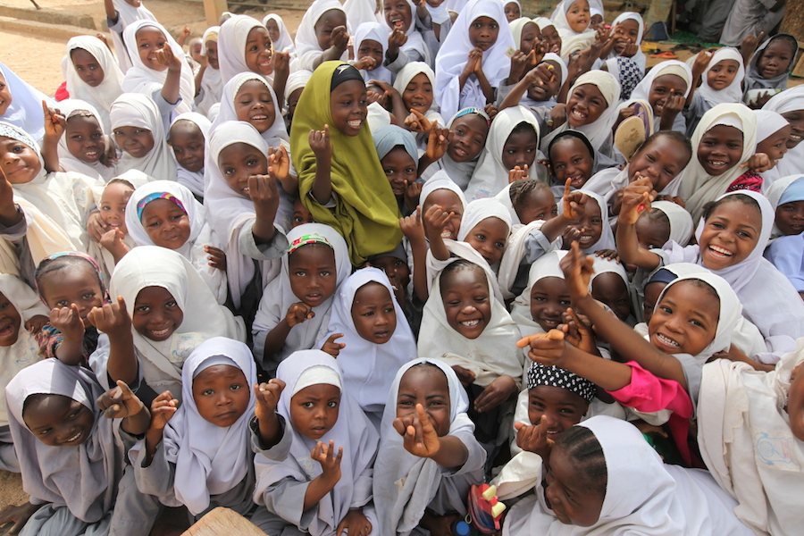 June, 2015. Girls at a religious school in Kano, Nigeria hold up their pinkies to show they have been immunized against polio.