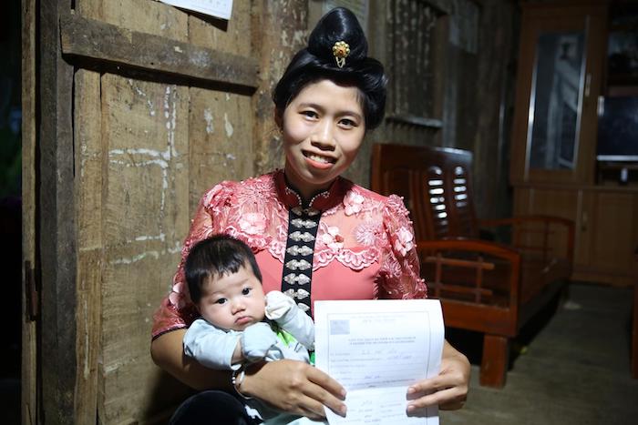 Lo Thi Son holds her baby at home in Huoi Sua, a remote village in northern Vietnam.