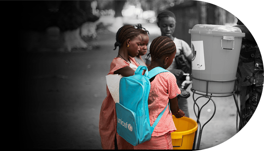 Children get water from a dispenser.