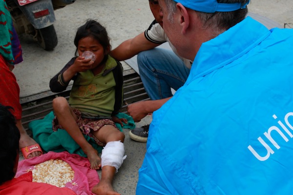 A UNICEF worker talks with the mother of a young girl, injured in Nepal's recent earthquake, at the Tribhuvan University Teaching Hospital in Kathmandu.