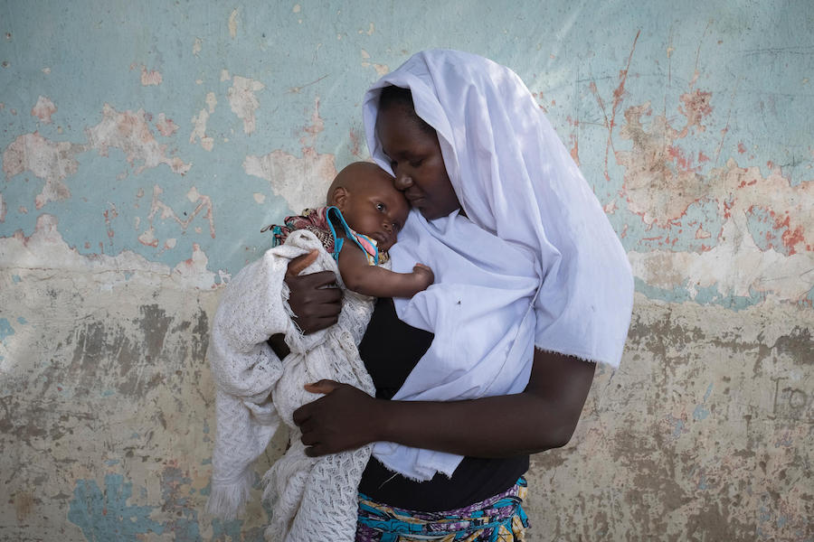 Esther, 19, holds her 6-month-old daughter, Becky, in Maiduguri, Borno State, Nigeria in July 2017. Becky was born after Esther was kidnapped and forced to marry a Boko Haram militant. 