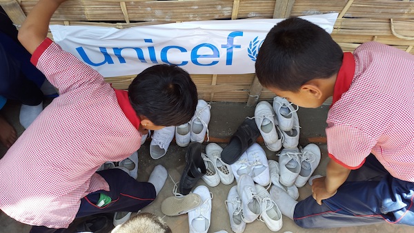 To keep their temporary learning space clean, children at the Kuleshwor School in Kathmandu, Nepal leave their shoes outside. 