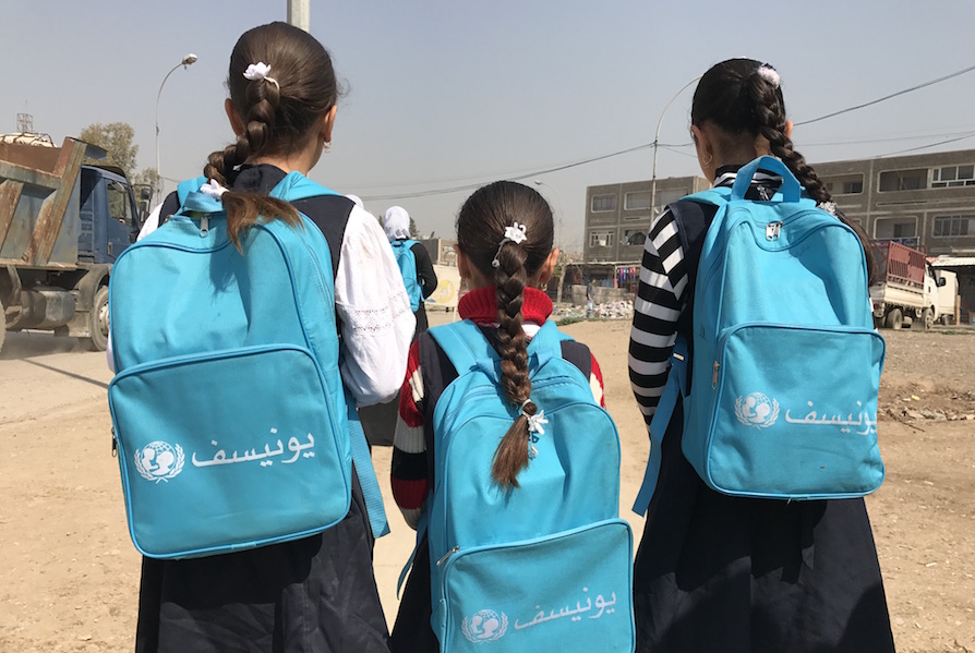 Girls with UNICEF-supplied backpacks return to school in Eastern Mosul, Iraq.