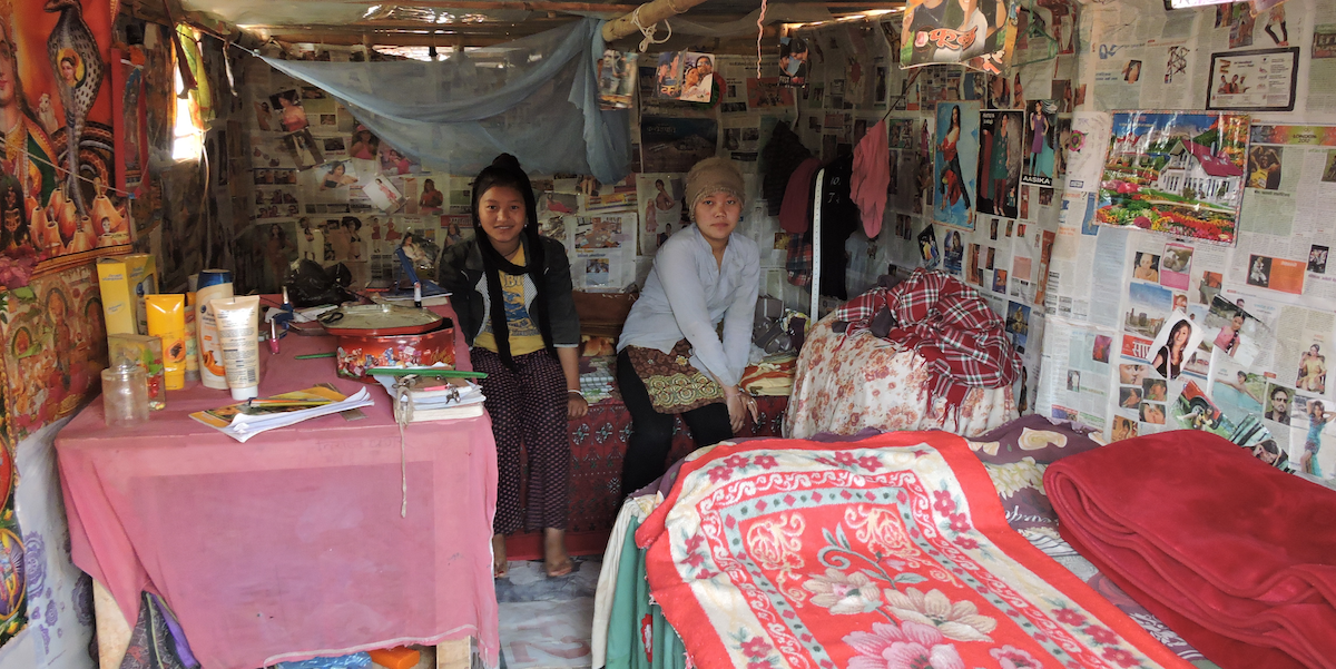 From left, Magar sisters Rita, 15, and Geeta, 17, are seen sitting inside their temporary shelter in Puranagaun village in Ramechhap.