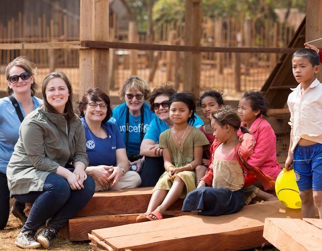 Sue Petrisin drawing with children in Cambodia during a recent field visit.