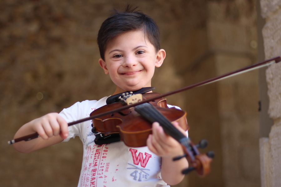 Somar, 8, is learning to play the violin in Aleppo City, Syria, thanks to a UNICEF-supported program. 