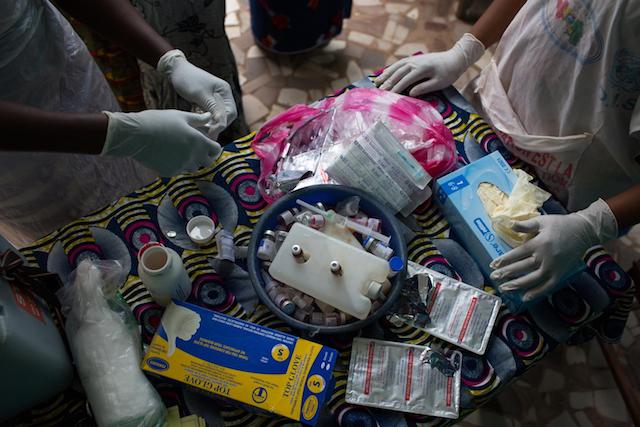 Nurses prepare to vaccinate children against polio and measles and administer deworming pills and Vitamin A at the Madina Health Center in Guéckédou, Guinea.