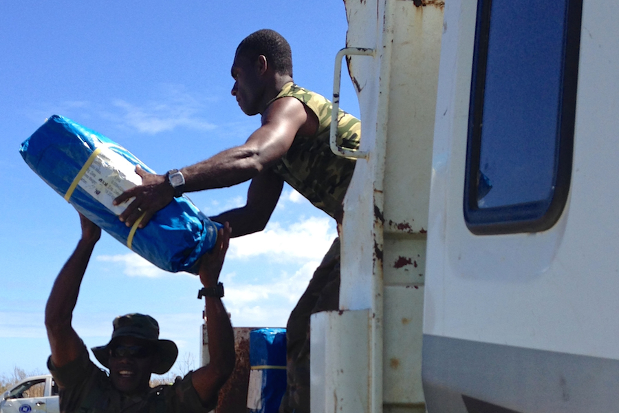 Soldiers load UNICEF relief supplies for urgent distribution to communities  on Tanna Island, Vanuatu.