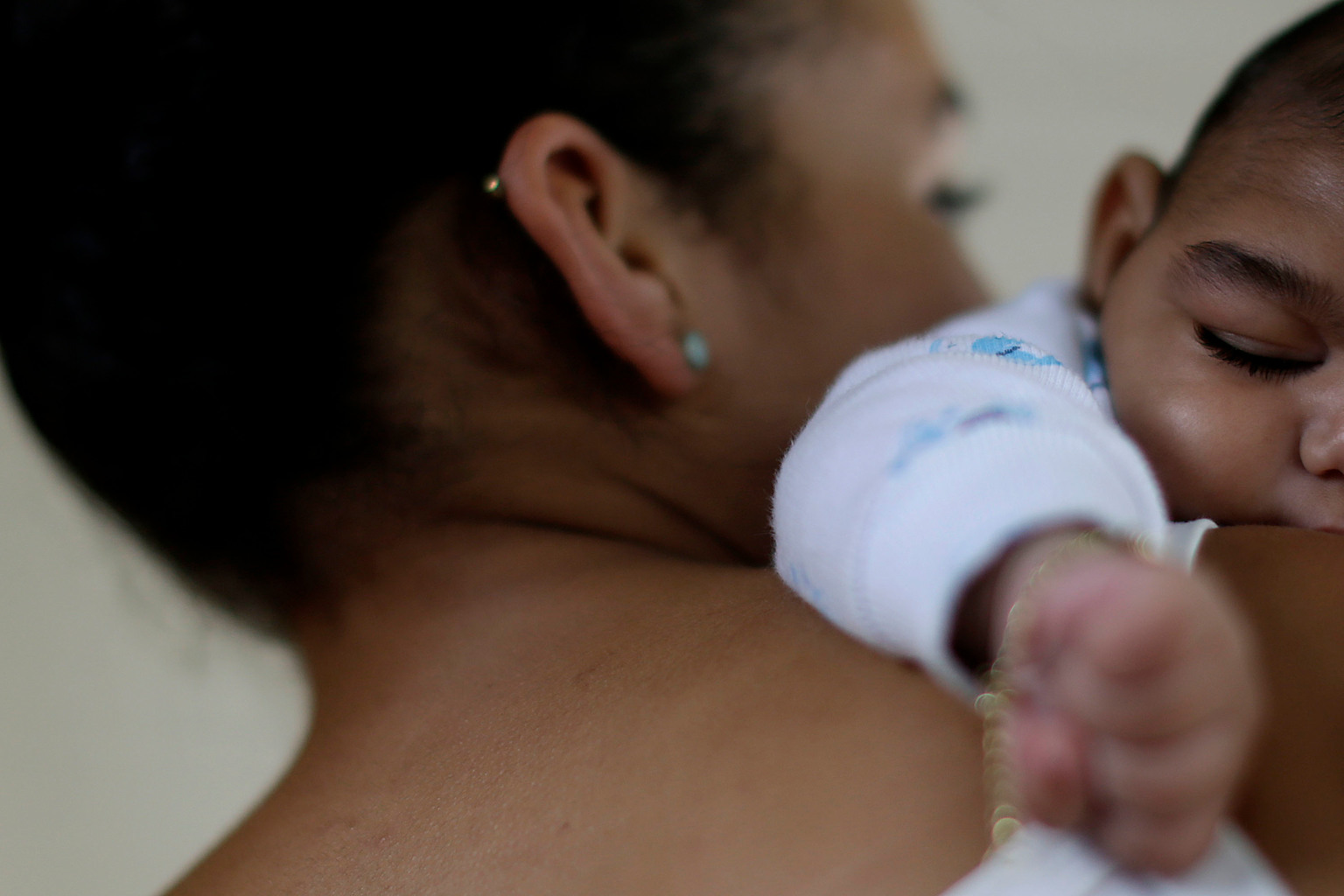 A 15-year-old mother holds her a 4-month old baby in Recife, Brazil. The mother was infected with Zika, and the baby was born with born with microcephaly.