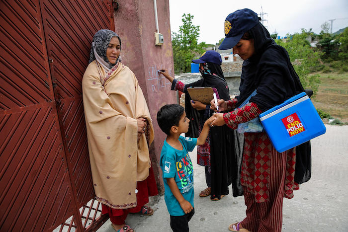 Frontline health workers go door-to-door to vaccinate children against polio in Islamabad, Pakistan in May 2017.
