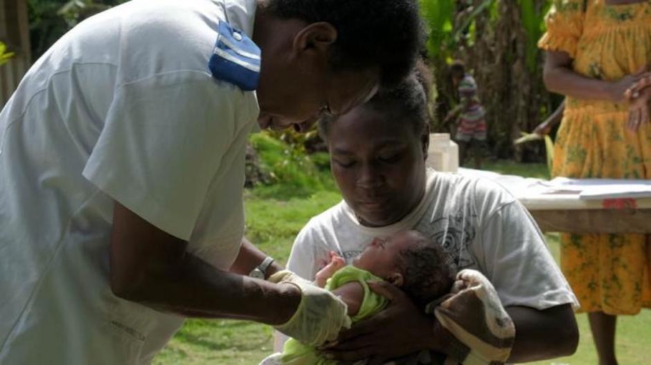 A UNICEF-supported health worker in Vanuatu administers a vaccine — delivered by commercial drone — to a one-month-old baby.
