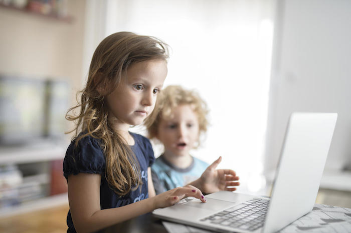 Milica, 6, and Petar, 4 from Podgorica, Montenegro, share a laptop.