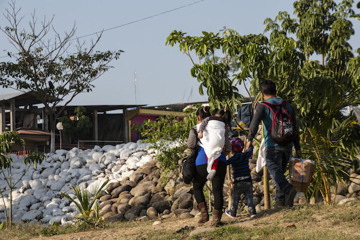 A migrant family from Guatemala crosses into Mexico.