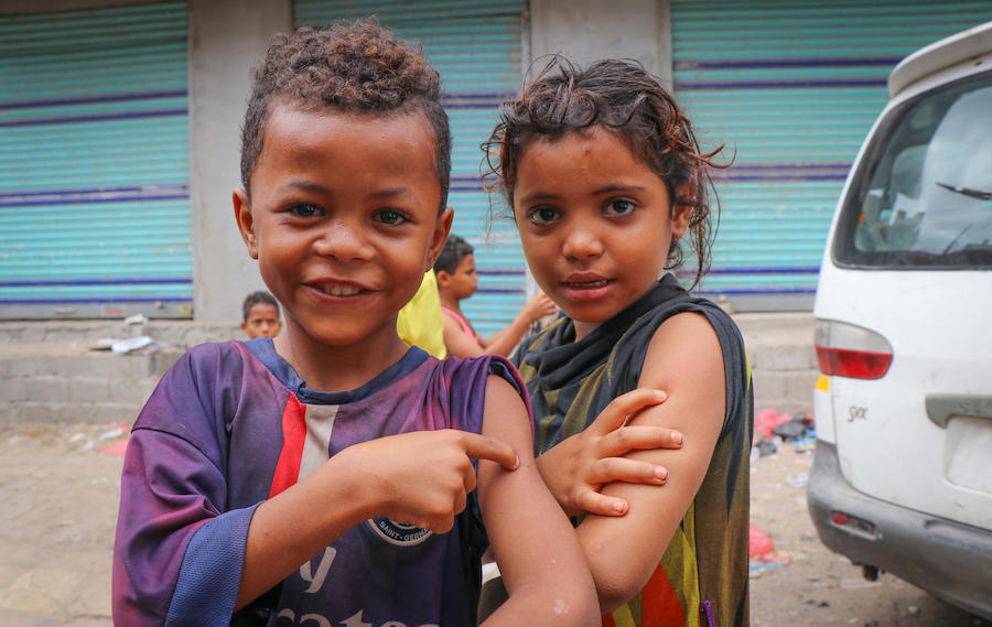 Children in Aden, Yemen proudly show off the spots on their arms where they were vaccinated during a mobile measles and rubella vaccination campaign backed by UNICEF in February 2019.