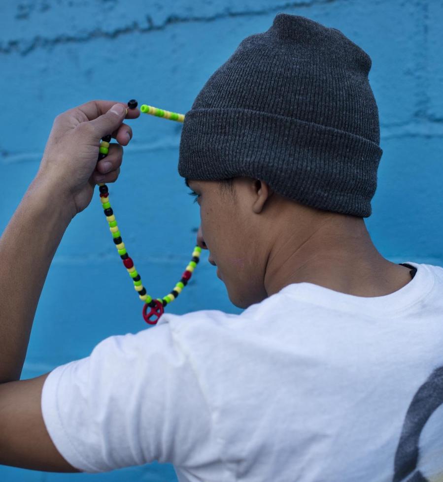Agustin*, 17, holds the necklace his mother gave him for good luck before he joined other migrants traveling in Guatemala. 