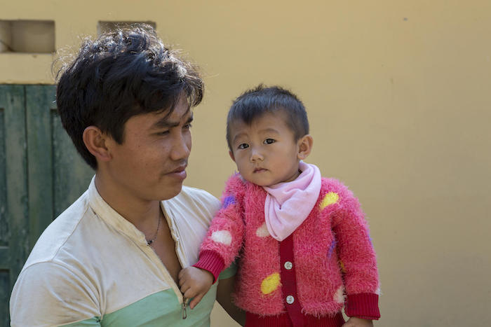Giang A Sinh, 25, holds his daughter Giang Thi Thuy Linh, waiting for her check-up at the UNICEF-supported Hua Ngai commune health center in Dien Bien, Vietnam after she was successfully treated for pneumonia at the district hospital. 