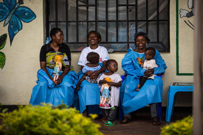 On March 19, 2019 in Beni, Democratic Republic of Congo, caregivers hold children inside the UNICEF-supported Ebola Treatment Center. 