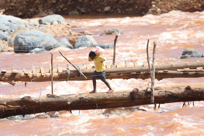 A young boy crosses a bridge near a spot where houses were swept away when Cyclone Idai hit Coppa in Risitu Valley Chimanimani in this Wednesday, April, 10, 2019 photo.The two boys both lost their parents when the cyclone struck the valley. Gore still rem A young boy crosses a bridge near a spot where houses were swept away when Cyclone Idai hit Coppa in Risitu Valley Chimanimani in this Wednesday, April, 10, 2019 photo.The two boys both lost their parents when the cyclone struck the valley. Gore still rem