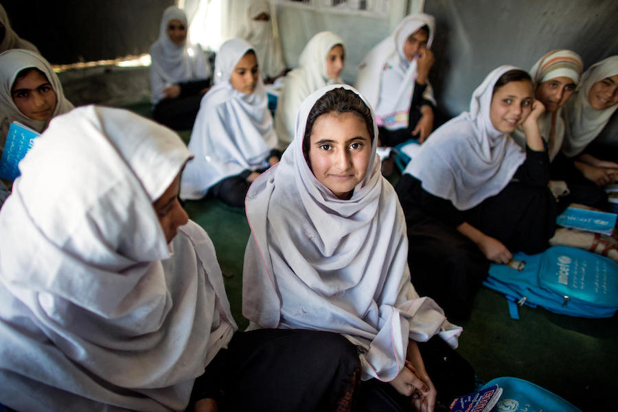 Kayenat, 12 (center), is back in school at the UNICEF-supported Zangora Community-Based Education (CBE) cluster in Surkhrod district, Nangarhar province, Afghanistan. 