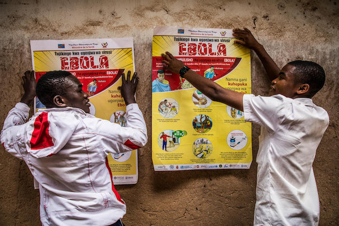 Students put up Ebola education posters on the walls of La Vérité school in Butembo, North Kivu, Democratic Republic of Congo on March 23, 2019.