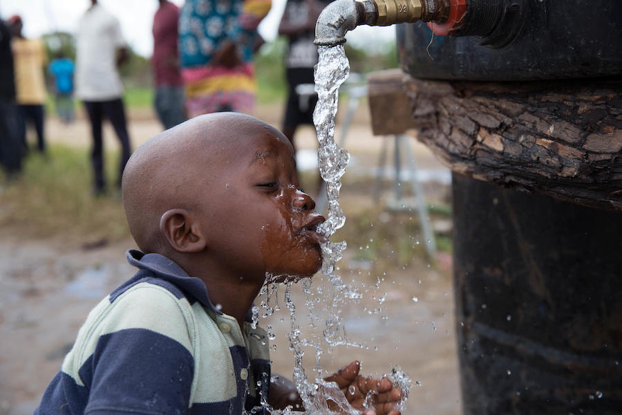 On April 4, 2019, in the wake of Tropical Cyclone Idai, a child drinks from a UNICEF-supported water point in Dondo, Mozambique.