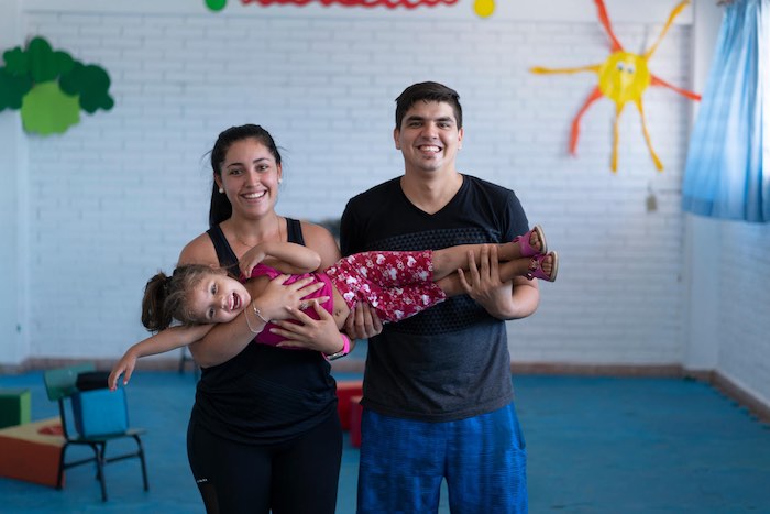 Leticia and David hold their daughter Xiomara at a UNICEF-supported Early Childhood Development (ECD) center in Paraguay's capital of Asunción 