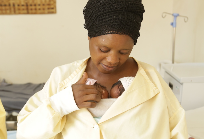 Mother Jyamima practices kangaroo care with her newborn twins at Gahini Hospital in Kayonza District, Rwanda, where health workers benefit from a UNICEF-supported mentorship program that emphasizes early and exclusive breastfeeding and other guidance.