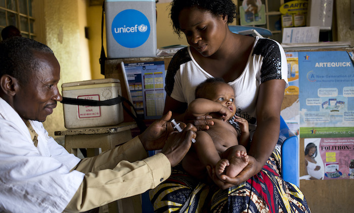 At UNICEF-supported Centre De Sante Le Rocher Maternity in Lubumbashi, Democratic Republic of Congo, a health worker vaccinates three-month-old Zoe against measles and rubella, tetanus and polio.