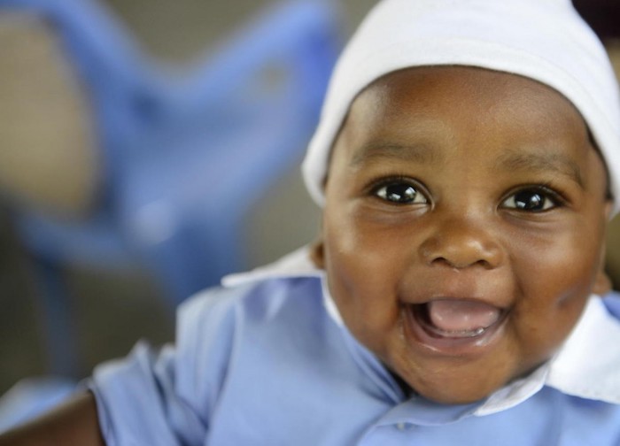 A happy baby waits for a check-up at a UNICEF-supported health center in the Democratic Republic of the Congo (DRC) in July 2019. 