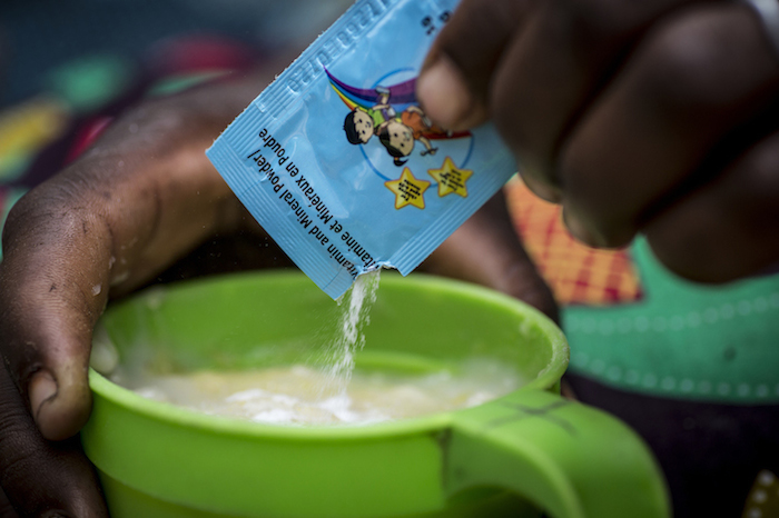 A sachet of micronutrient powders is sprinkled into a serving of porridge to fortify a child’s diet and prevent stunting and other long term effects of malnutrition.