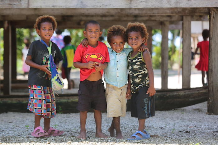 Children outside the Taemigidu Early Childhood Development Center, Nawaeb District, Morobe, Papua New Guinea.