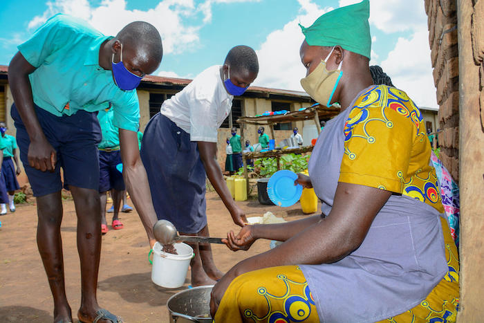 Children who attend Abongodic Primary School, in Balla subcounty, Kole District, Uganda, are served food as part of a development initiative supported by UNICEF and partners