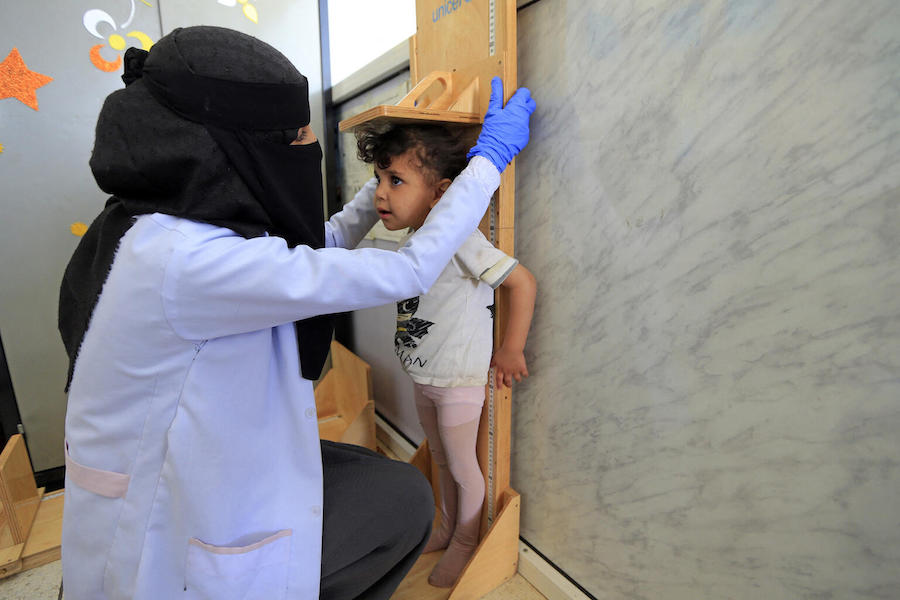 On March 21, 2021, a Yemeni health worker measures the height of a girl in the malnutrition ward of al-Sabeen Maternity and Child Hospital in the country’s capital, Sana’a.