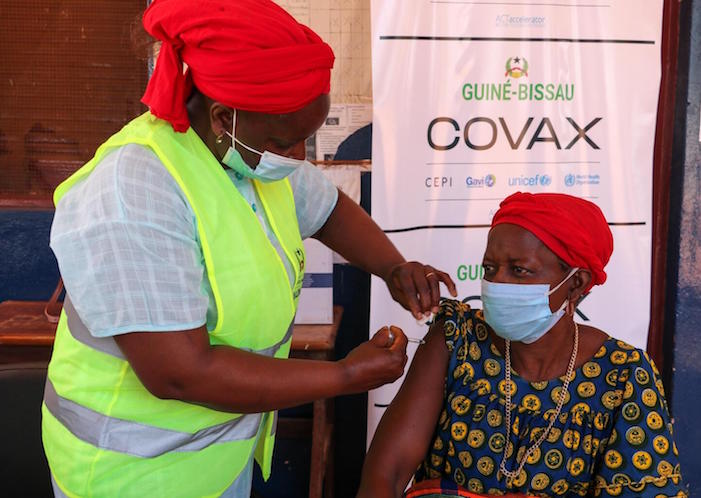 A health worker administers a COVID-19 vaccine dose supplied by the COVAX Facilty in Guinea-Bissau on May 25, 2021. 
