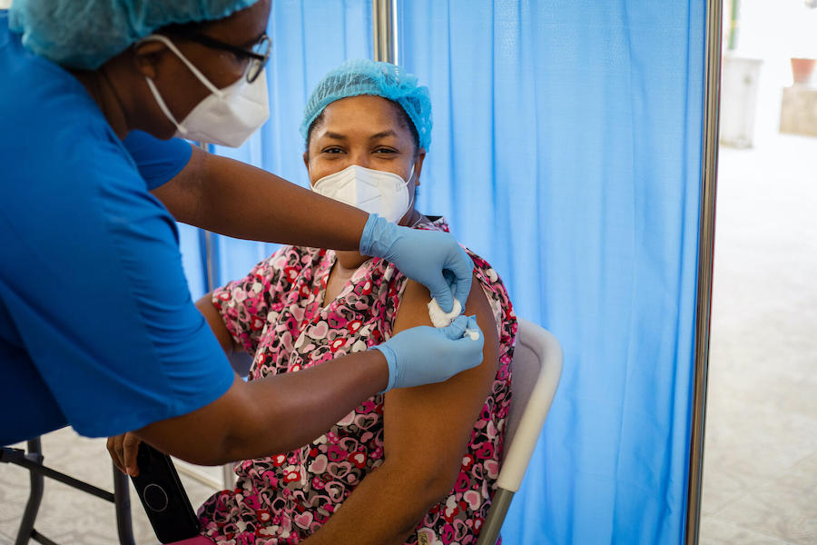 A neonatal nurse in Port-au-Prince is vaccinated against COVID-19 as Haiti launches its national immunization campaign on July 24, 2021.