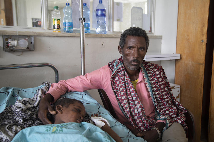 Barhe Atsma watches over his 10-year-old Shumuye, resting in his hospital bed in Ayder Hospital in Mekelle, the capital of Ethiopia's Tigray region. 