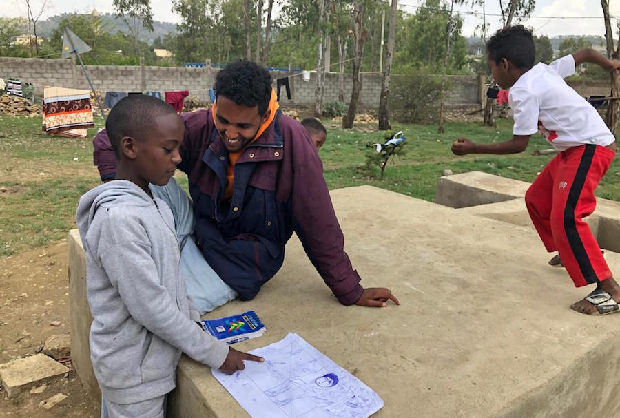 Displaced from his home by conflict in northern Ethiopia, 11-year-old Temesgen, left, is living with his family in an emergency shelter in a school in Mekelle in 2021.