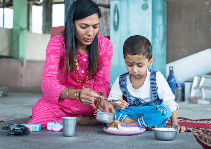 Laxmi Chhetri feeds her 3-year-old son, Aarav, on the terrace of her parents' home in Gaidakot, Nawalpur District, Nepal. 